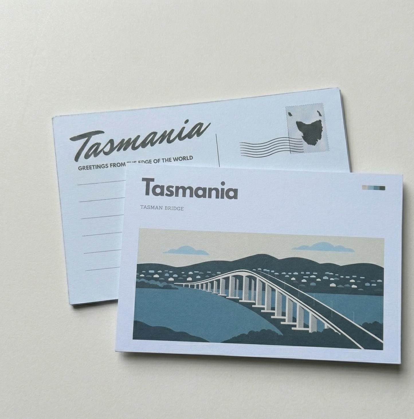 Two postcards with 'Tasmania' branding on a light gray background
